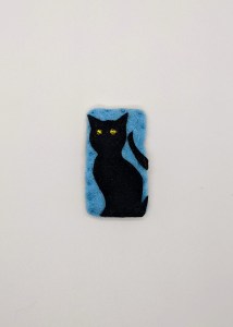 black cat with yellow eyes on blue background