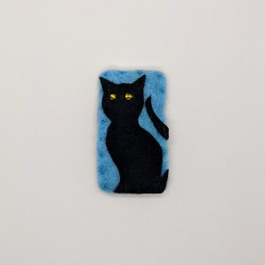 black cat with yellow eyes on blue background